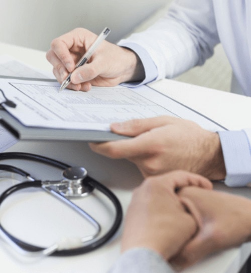 close-up-doctor-filling-medical-form-with-patient